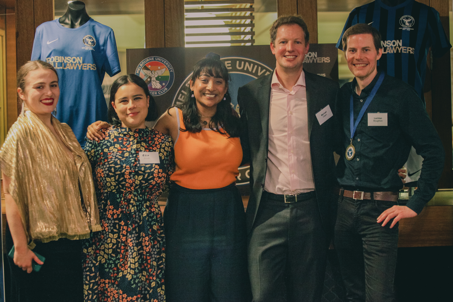 Ellie is standing second from left in a group of five people facing the camera at MUSC's 75 anniversary celebrations.